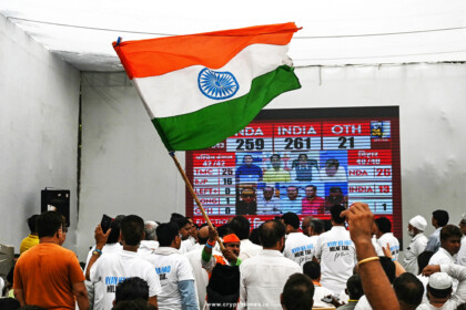 Indian public watching the election result while keeping India flag in Hand.